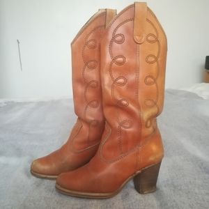 Vintage leather cowboy boots with sassy stacked heels, golden brown.